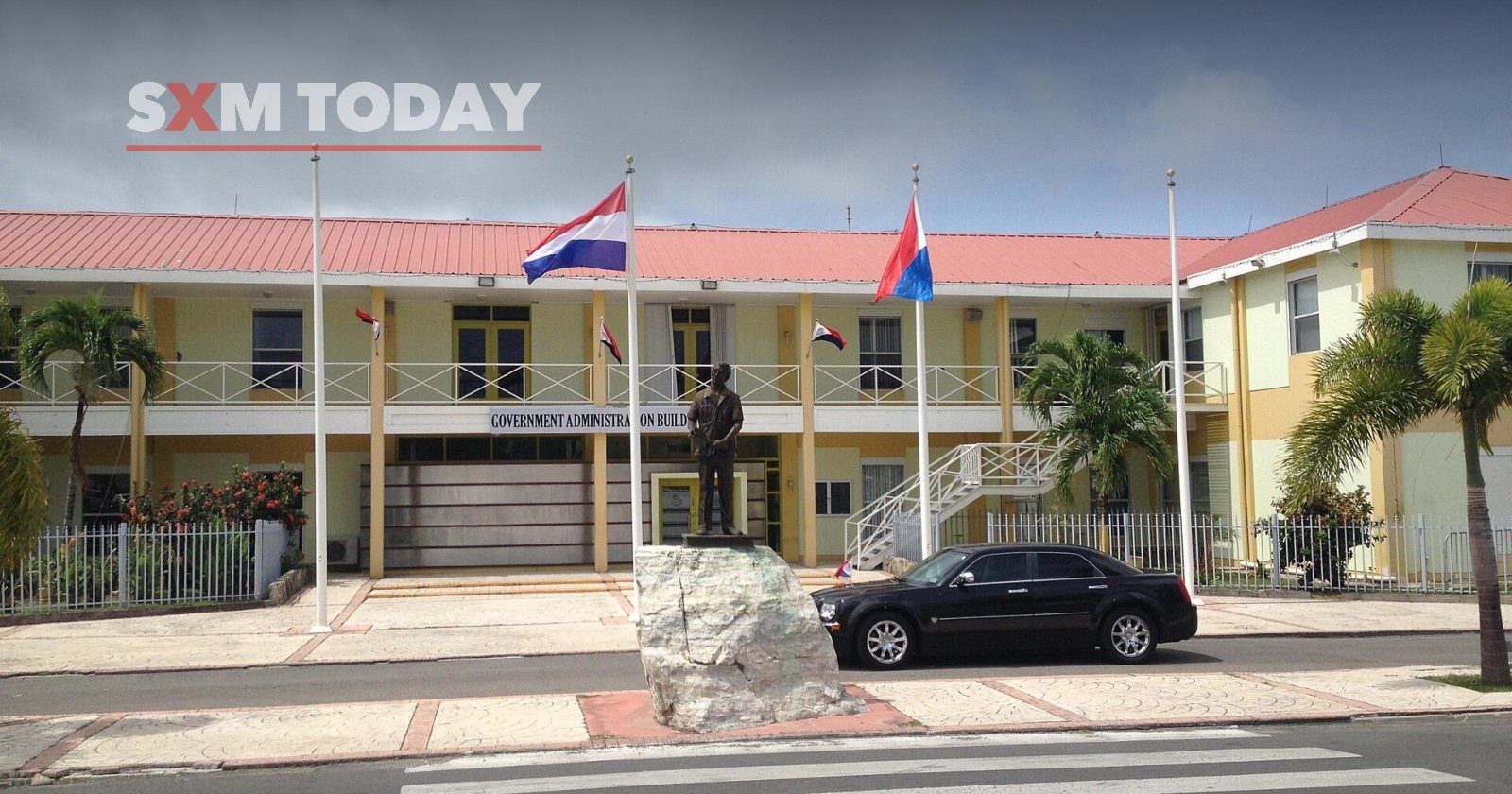 The Government Administration Building in Philipsburg, with the Dutch and Sint Maarten flags flying in front.