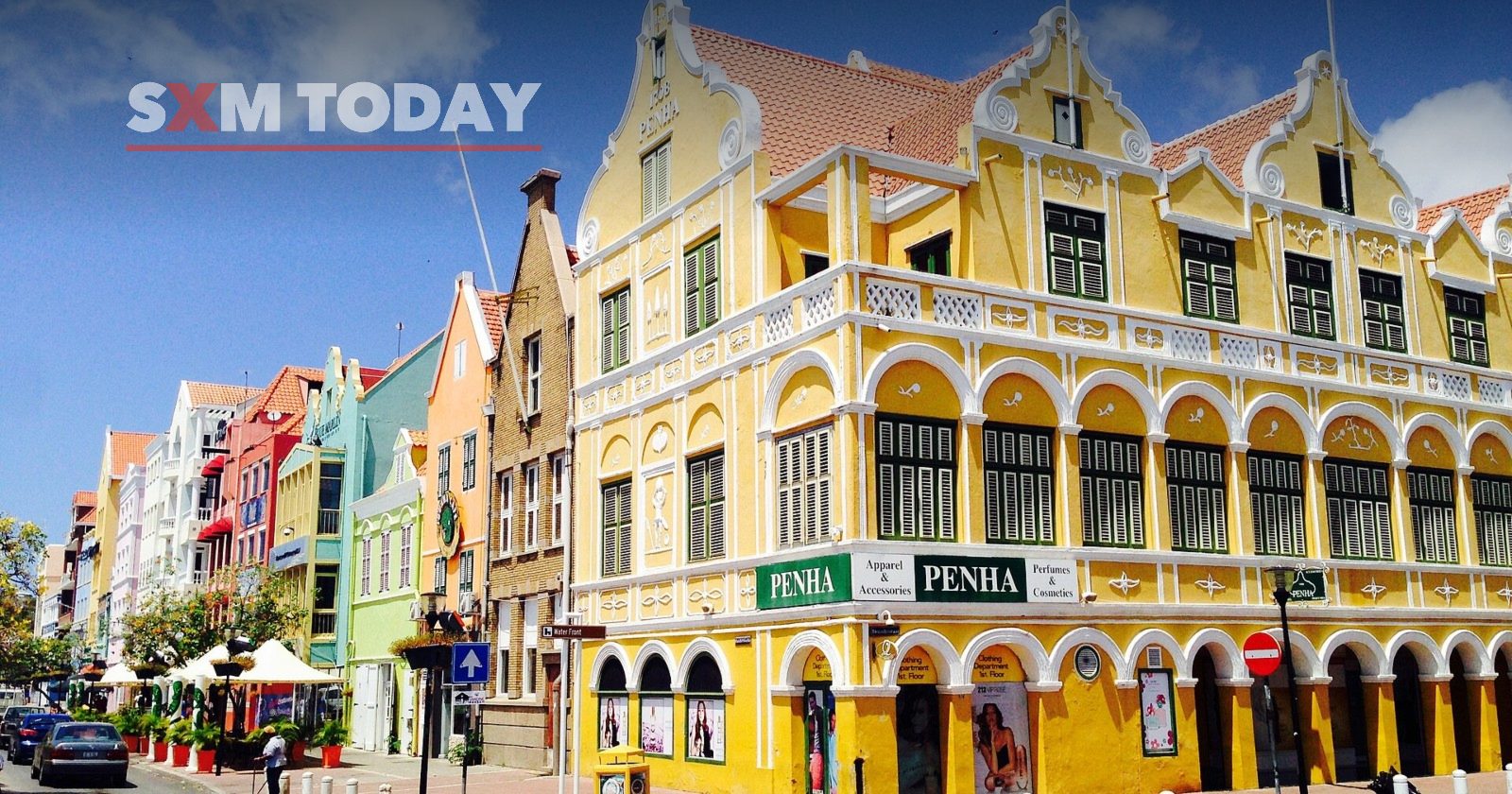 Yellow and pastel colonial buildings on a street corner in Punda, Willemstad, Curaçao.