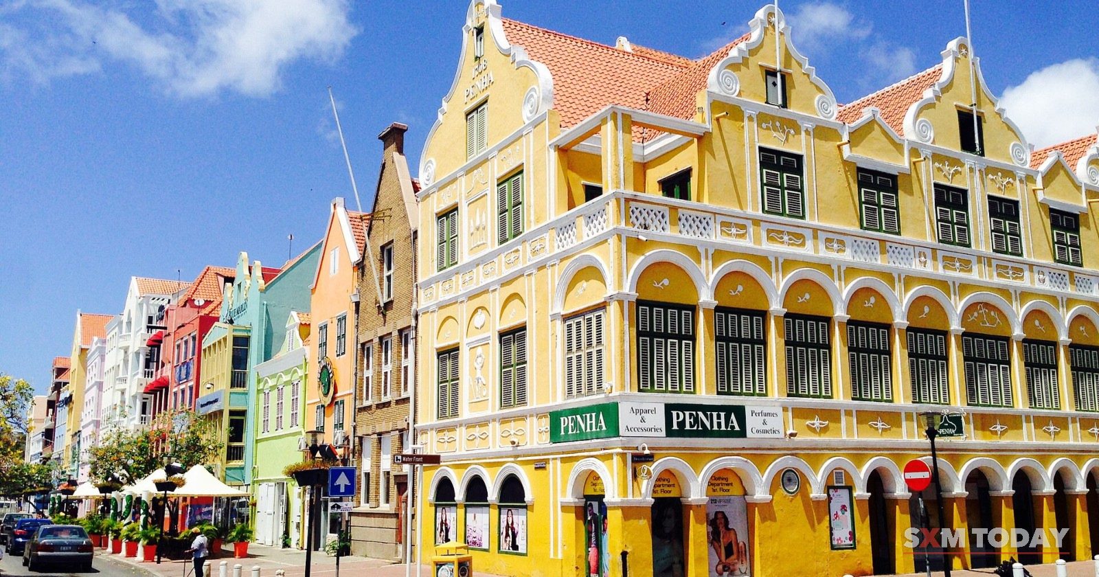 Yellow and pastel colonial buildings on a street corner in Punda, Willemstad, Curaçao.