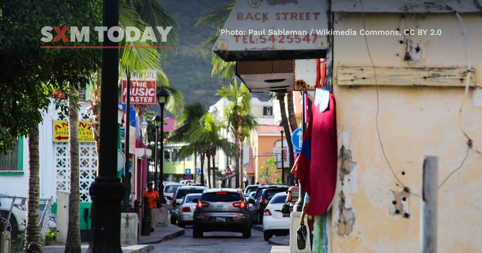 Cars queue along Back Street in Philipsburg.
