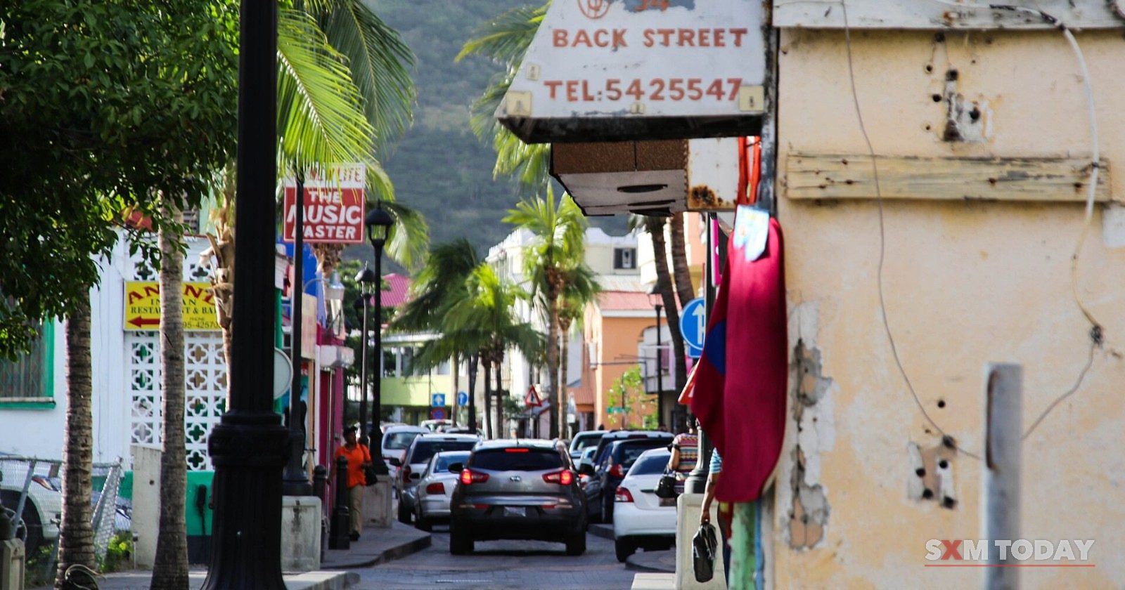 Cars queue along Back Street in Philipsburg.