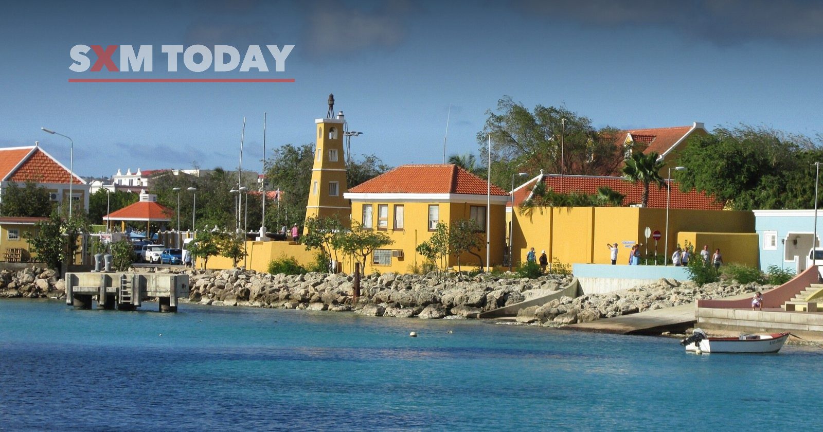 The Kralendijk waterfront in Bonaire, with the Fort Oranje lighthouse and yellow buildings by the sea.