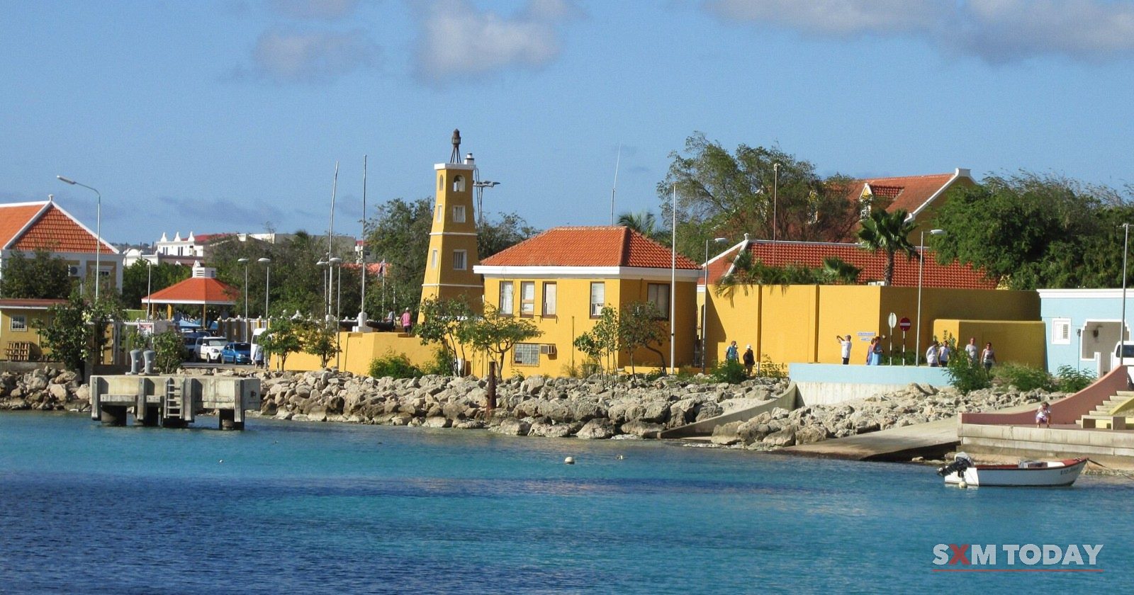 The Kralendijk waterfront in Bonaire, with the Fort Oranje lighthouse and yellow buildings by the sea.