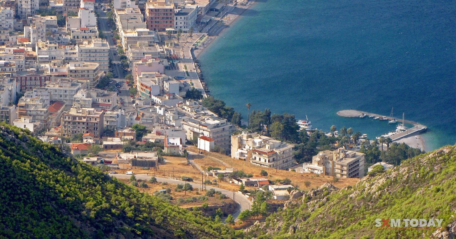Loutraki, Greece, seen from the hills, its streets running down to the Gulf of Corinth.