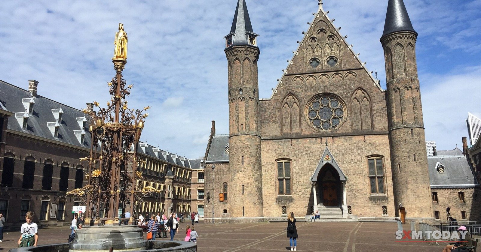The Binnenhof courtyard in The Hague, with the twin-towered Ridderzaal and a gilded fountain.