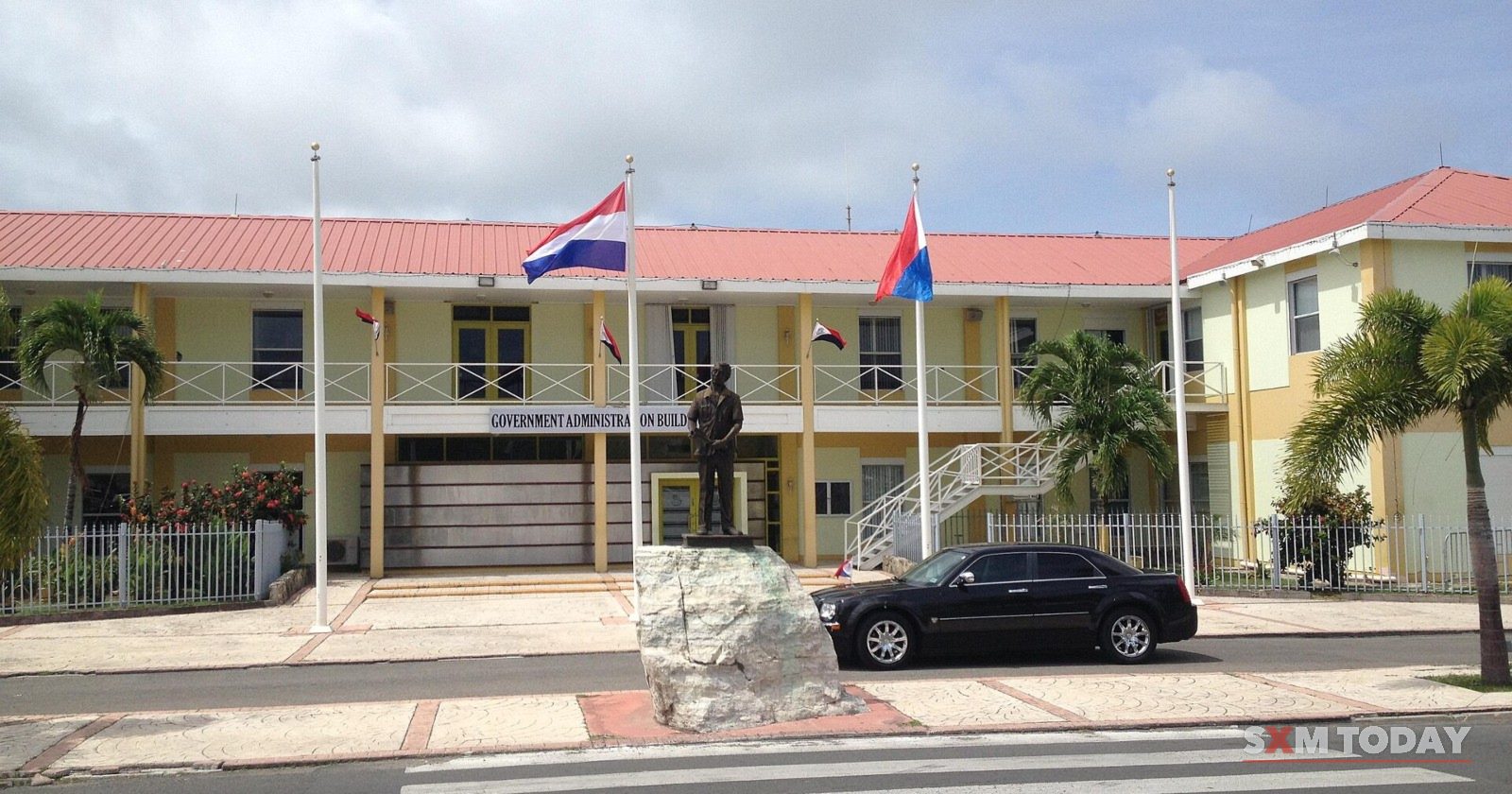 The Government Administration Building in Philipsburg, with the Dutch and Sint Maarten flags flying in front.
