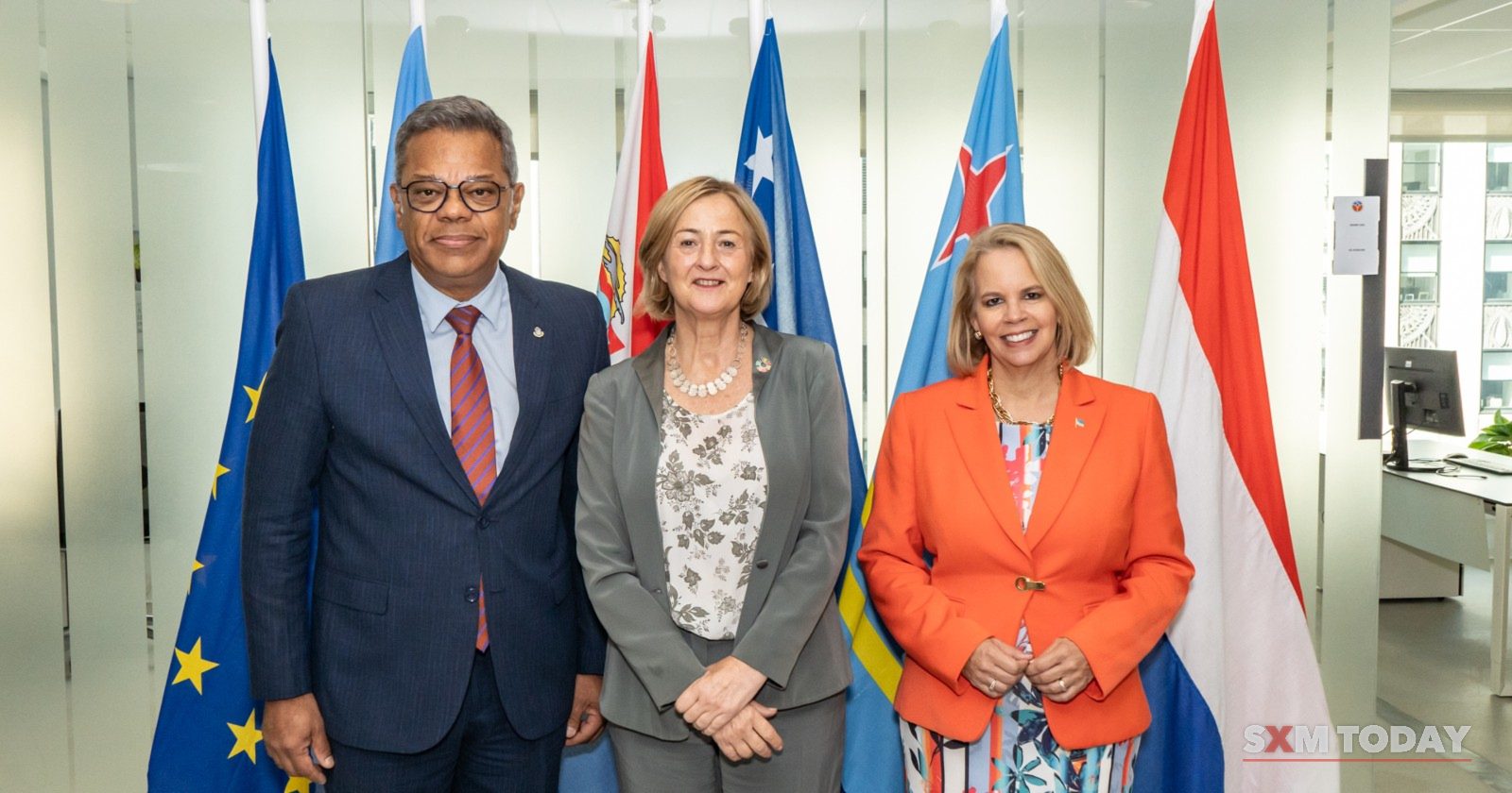 Luc Mercelina, left, with Evelyn Wever-Croes and Joke Brandt in front of the Kingdom's flags at the UN General Assembly in New York, September 2024.