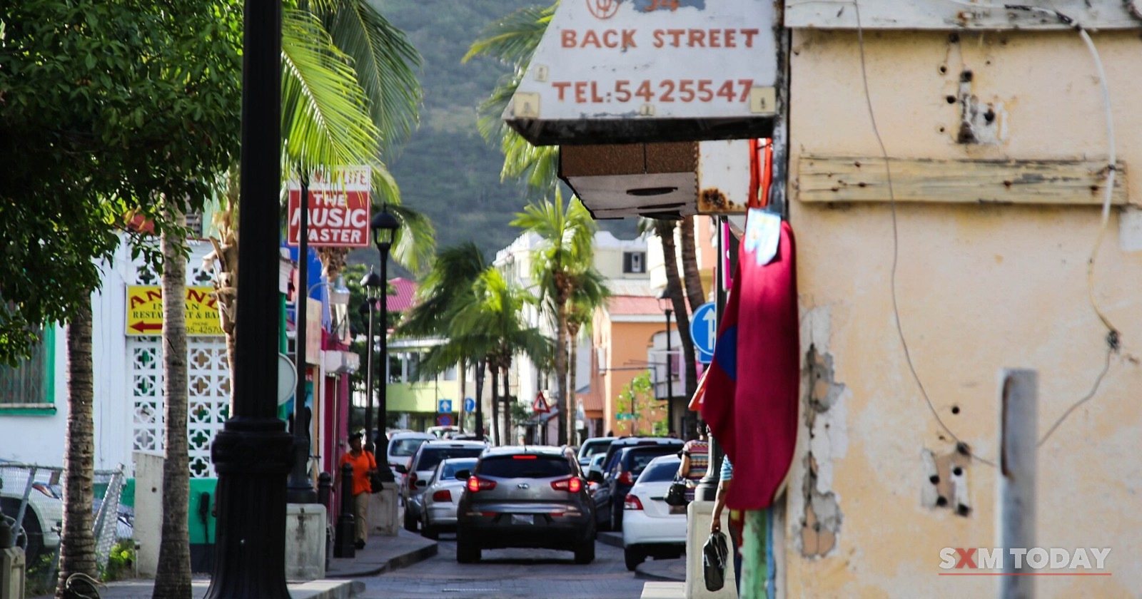 Cars queue along Back Street in Philipsburg.