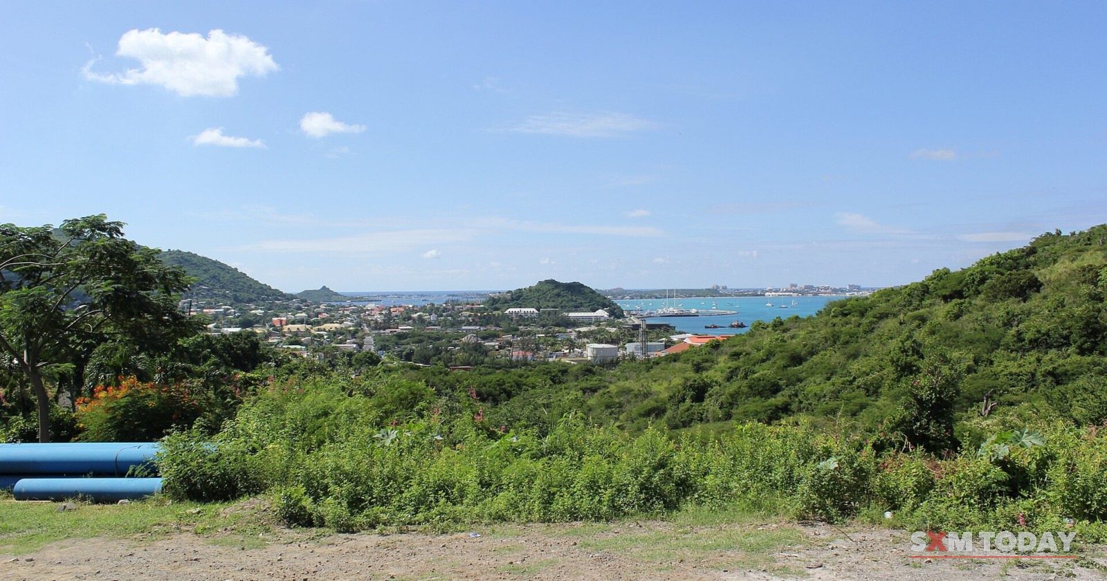 Looking down over scrub towards Philipsburg and its harbour from the hills.