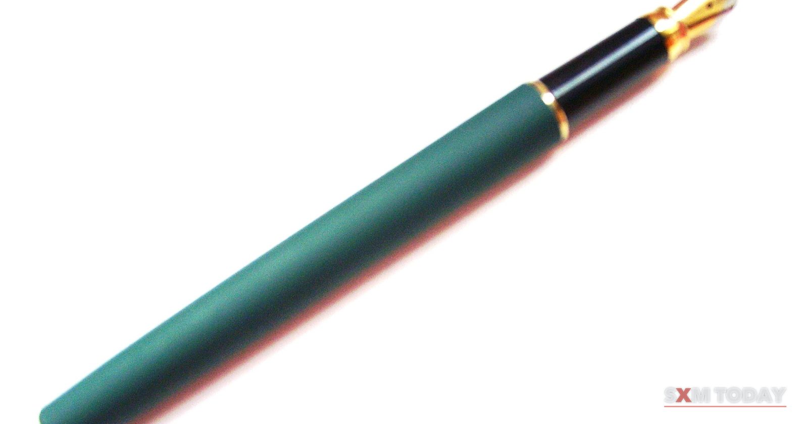 A green fountain pen with a gold nib, uncapped, on a white background.