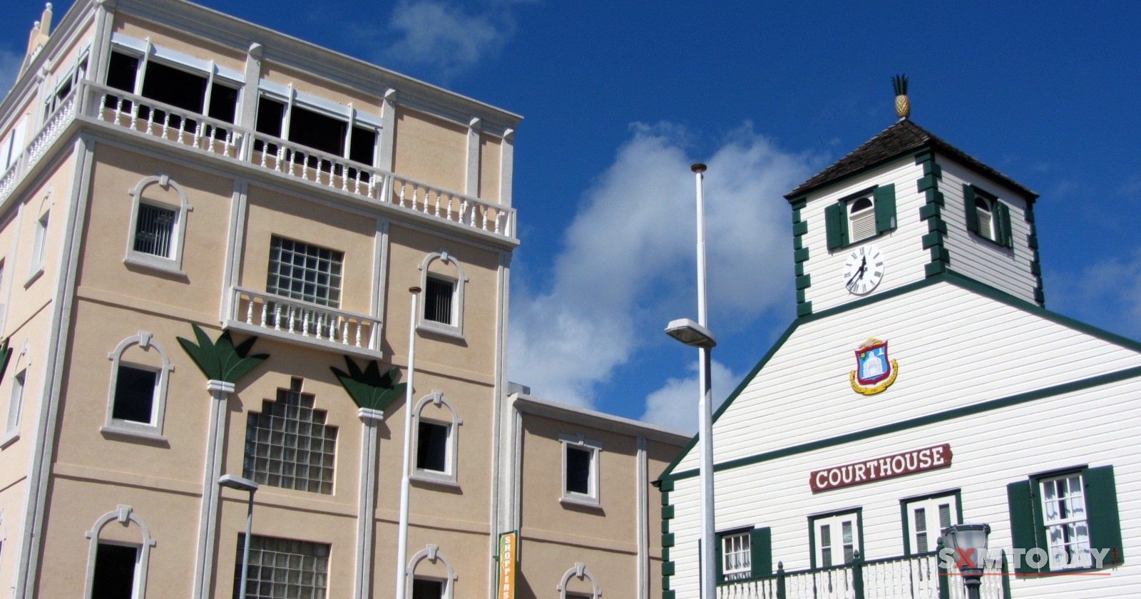 The Parliament of Sint Maarten building beside the white wooden Courthouse in Philipsburg.