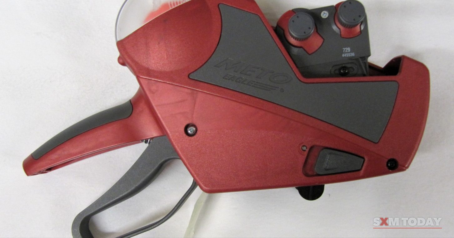 A red and grey handheld price-labelling gun on a white background.
