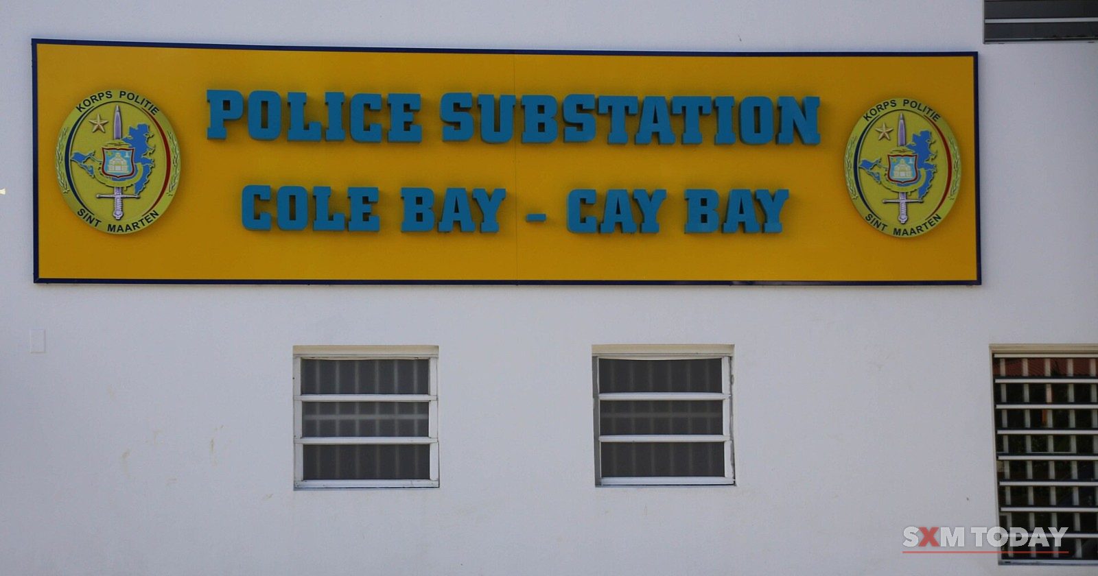 The sign on the Sint Maarten police substation in Cole Bay, with the police crest on either side.