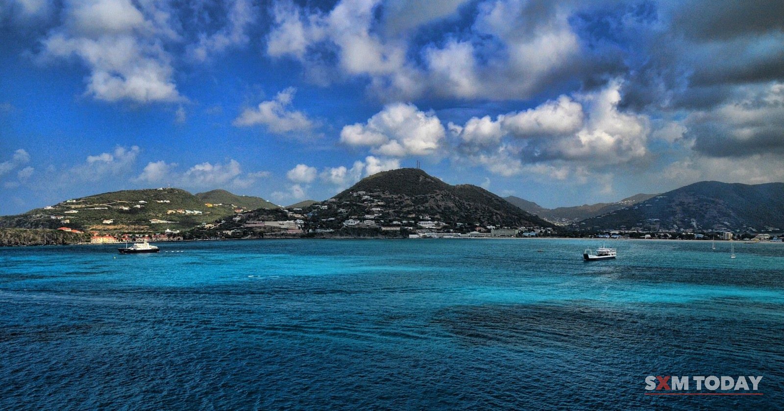 Great Bay and the hills around Philipsburg under heavy white clouds.